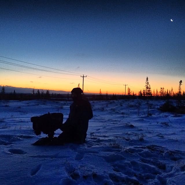 Craig Kevin Beck with camera at dusk in the snow